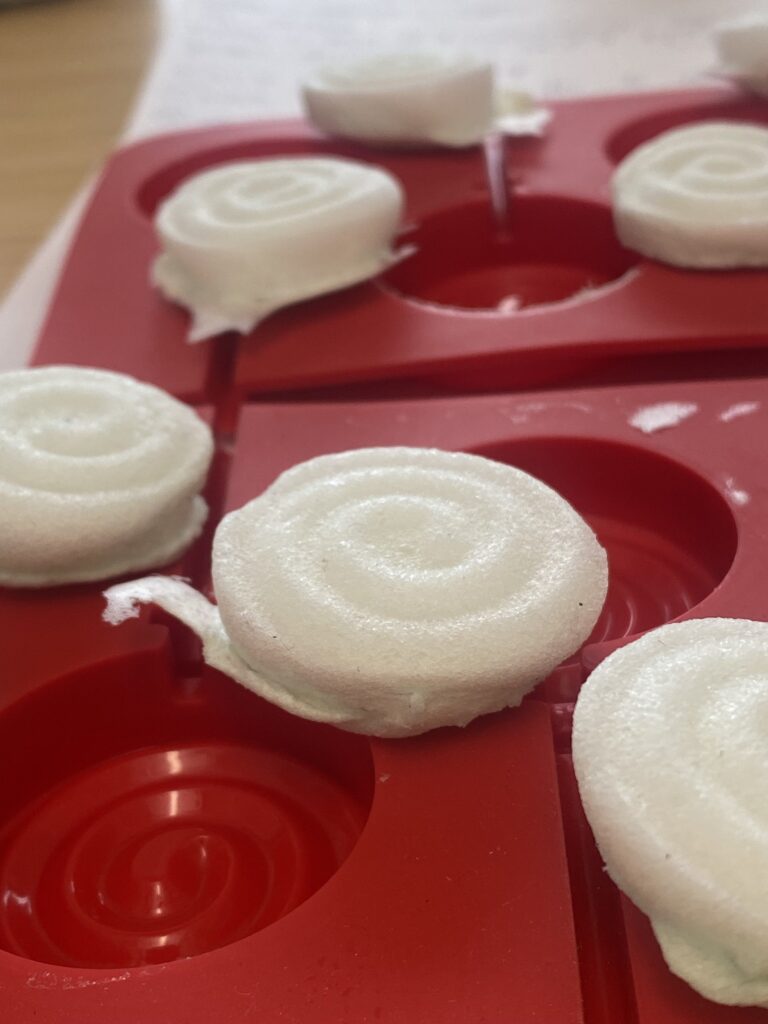 Dried biofoam spirals removed from candy mold and placed on top.