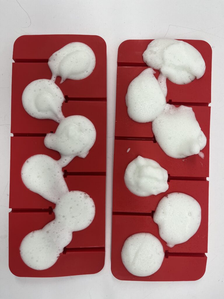 Biofoam drying in red silicone candy molds.