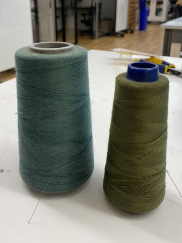 Two green spools of thread.