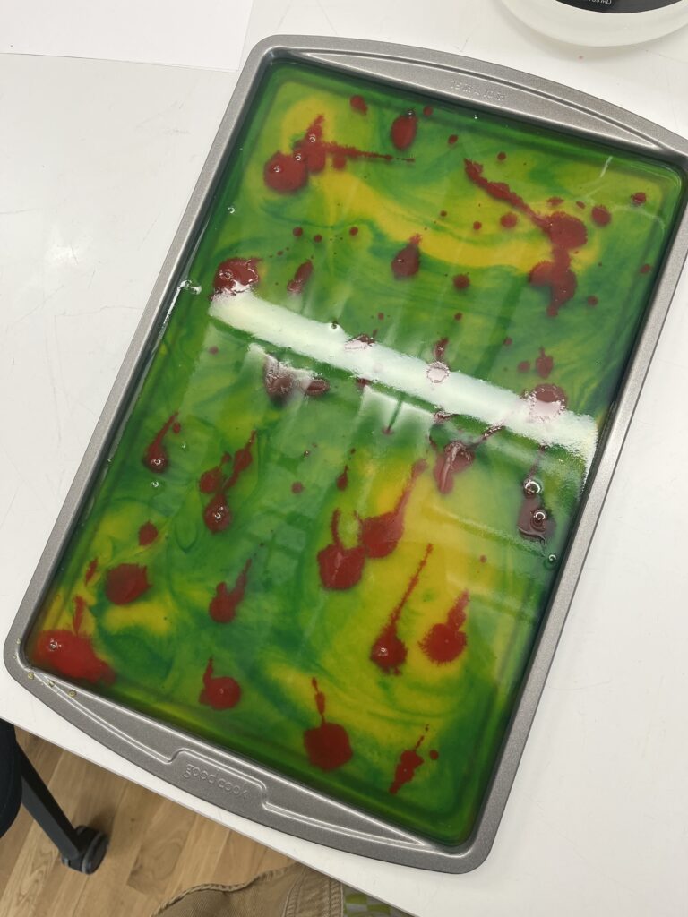 Multicolored agar agar bioplastic in baking sheet.