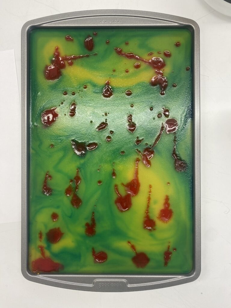 Multicolored agar agar bioplastic in baking sheet.