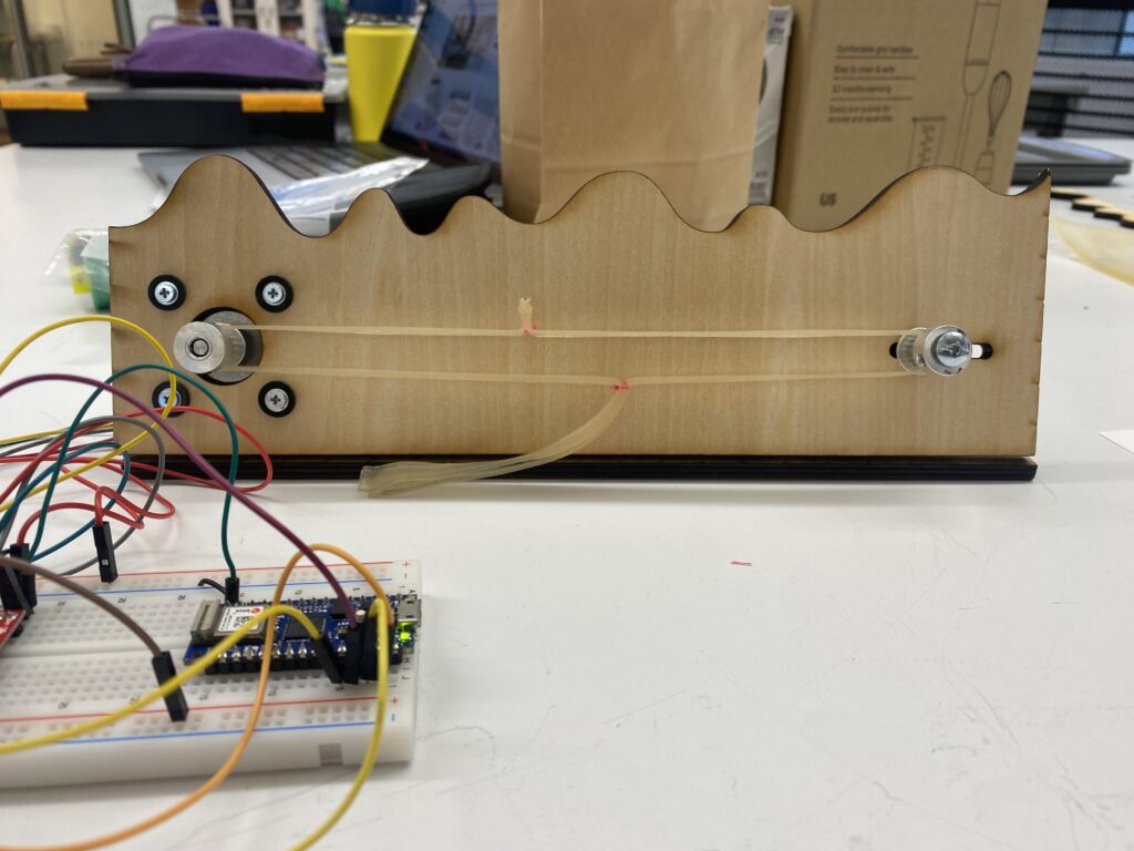 Bioplastic timing belt attached to motor system and mount.