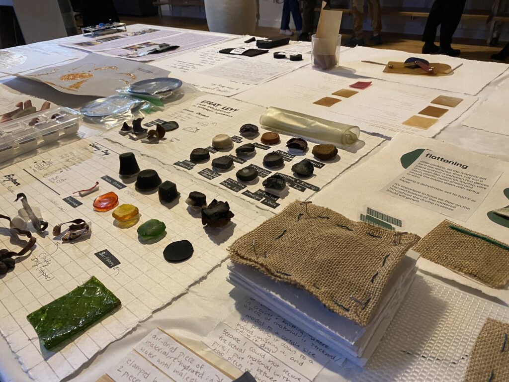 Table full of students biomaterial swatches and documentation.