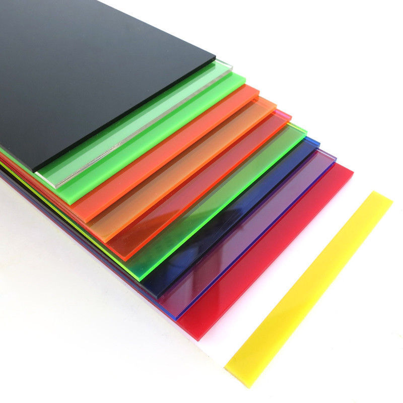 Stack of colorful acrylic plastic sheets on white background.