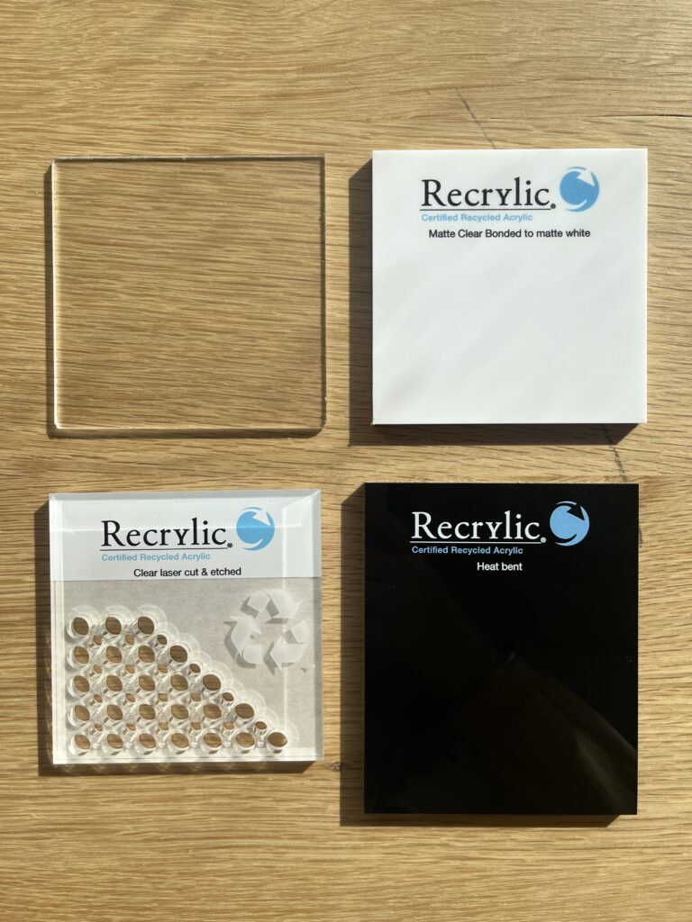 Four acrylic plastic squares of sample material received from Recrylic.