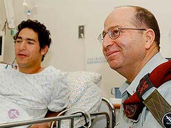 Gil being visited in hospital by Moshe Yaalon, the Israeli military's then chief-of-staff