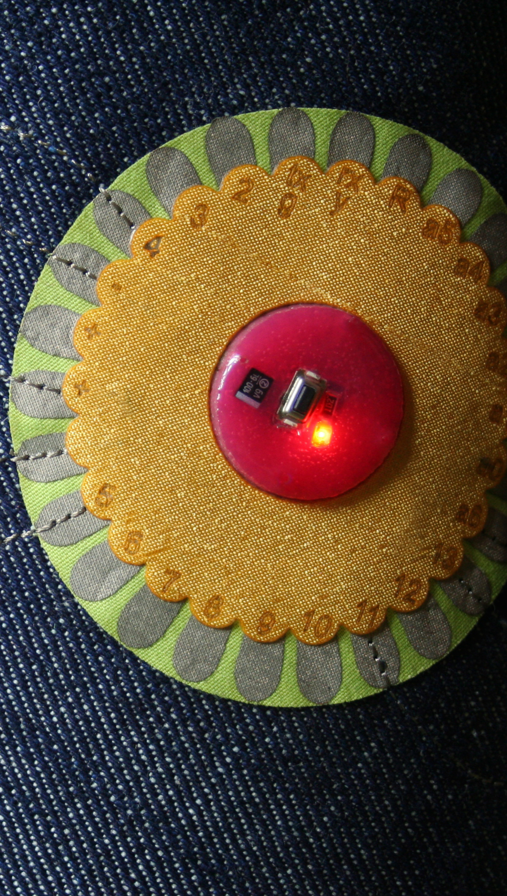 a multi-petal form that exists as a microcontroller, attached to jeans