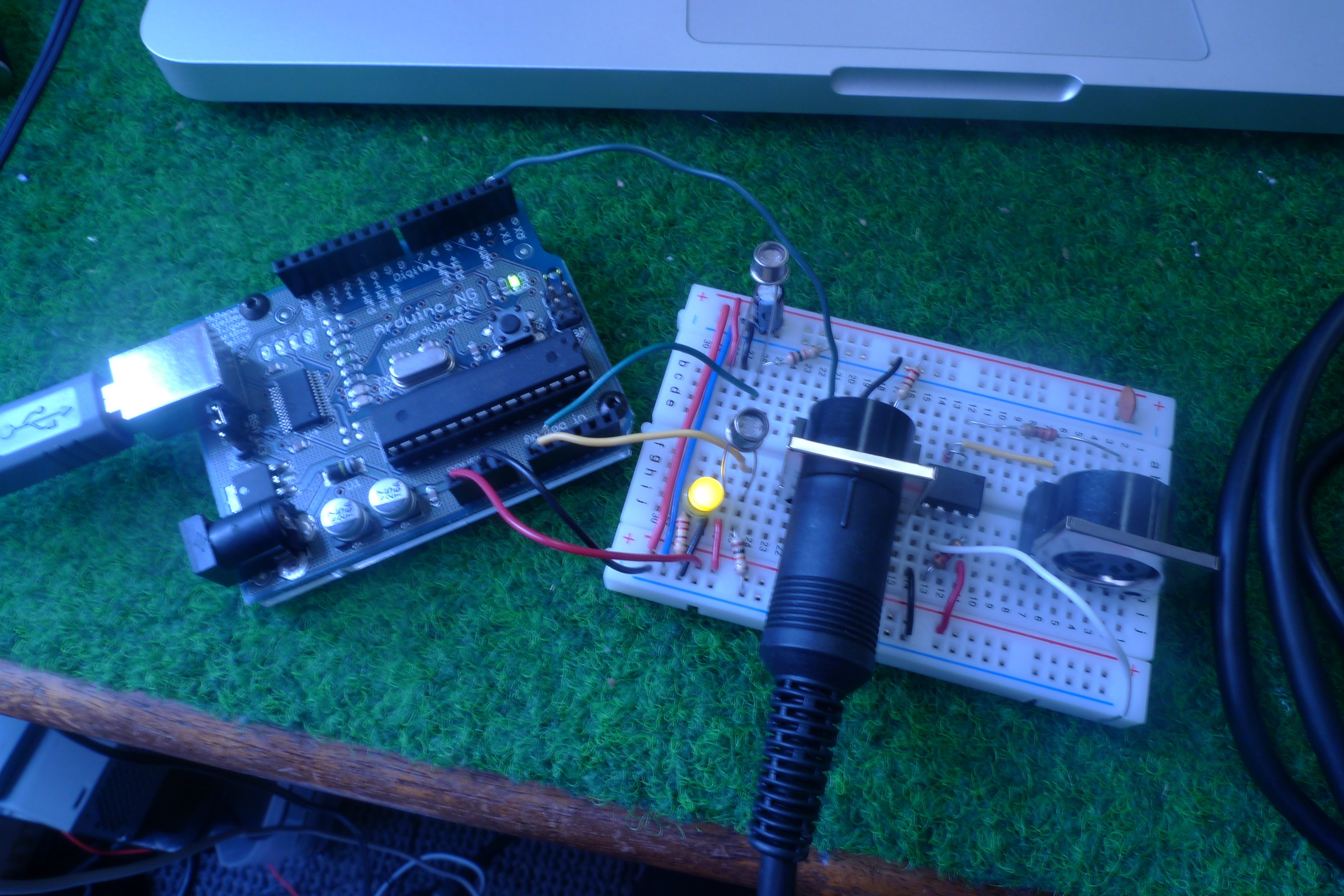 Photo of an Arduino connected to a breadboard. The breadboard contains a MIDI output circuit like the one shown above.