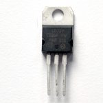 3.3-volt regulator, model LD111733V. This component has three legs and a tab at the top with a hole in it. If you hold the component with the tab at the top and the bulging side of the component facing you, the legs will be arranged, from left to right, ground, voltage output, and voltage input. The back tab is attached to the voltage output pin.