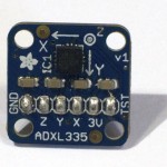 An ADXL335 accelerometer module. There are six pins along the bottom, labeled GND, Z, Y, X, 3V, and ST (left to right)