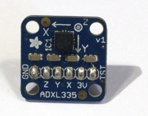 An ADXL335 accelerometer module. There are six pins along the bottom, labeled GND, Z, Y, X, 3V, and ST (left to right)