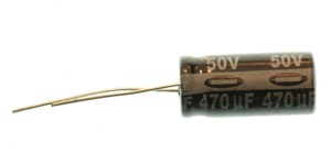 Electrolytic capacitor, showing the minus sign on the negative side. This component has a tubular top and two wire legs coming out of one end of the tube. They are generally polarized. The longer leg is the positive leg. You measure the capacitance between the two legs. Electrolytic capacitors are generally higher capacitance than ceramic capacitors.