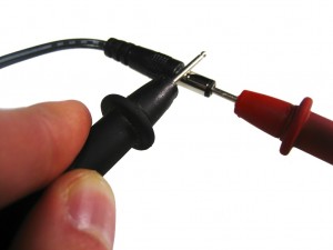 Testing a center positive power supply with a multimeter. Red probe goes into the tip Black probe touches the barrel