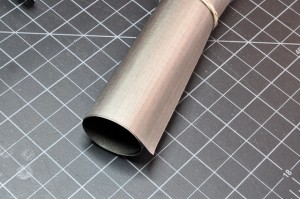 Photo of a roll of grey fabric made of conductive threads.