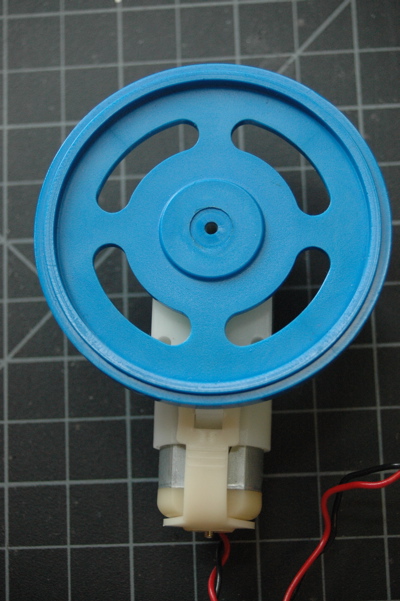 DC geared motor, hobby size. The motor shaft has a round blue hub attached.