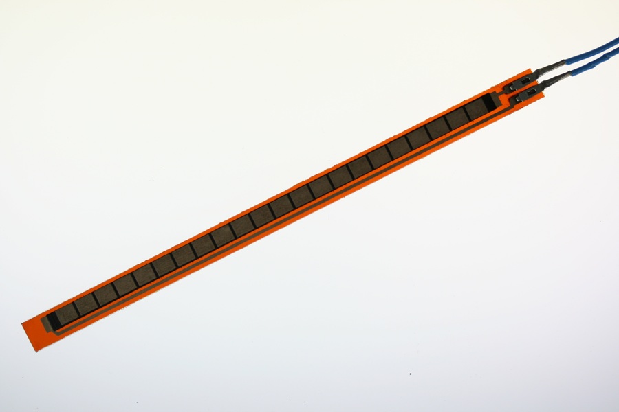 Photo of a flex sensor. A plastic strip approx. 0.25 inches wide by 6 inches long, with pins at one end. When you bend the sensor, the resistance between the pins changes