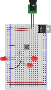 A pushbutton is mounted across the center of the breadboard, connected to rows ten and twelve. A red wire connects the switch to the left side voltage bus. A 220-ohm resistor is connected to row twelve on the left side of the center section of the board. Its other end is connected to row sixteen in the center area. Three LEDs' anodes are connected to another hole in row sixteen. The cathodes of the LEDs are connected to holes in row seventeen. A black wire connects row seventeen to the ground bus on the left side of the board.