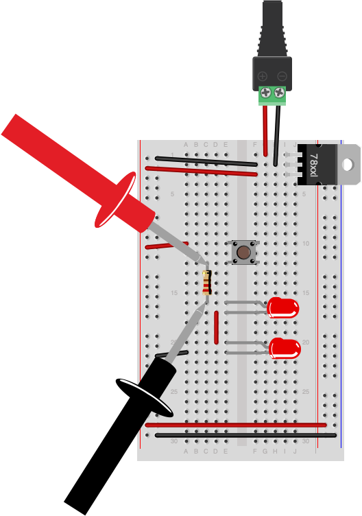 Breadboard drawing of a solderless breadboard as shown in the drawing above, with a 5-volt voltage regulator, a pushbutton, a 220-ohm resistor and 2 LEDs. The red probe of a multimeter is touching the side of the resistor that's connected to the pushbutton. The black probe of the meter is touching the other side of the resistor.