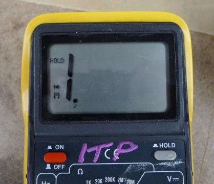 Photo of a multimeter's top half, showing the screen and the power button on the left, and the hold button button on the right. Not all meters are arranged in the same way, so check your manual for the location of the buttons on yours.
