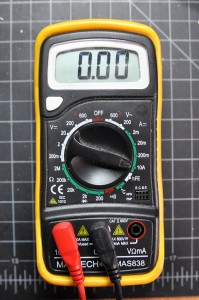 Photo of a multimeter set to measure High DC Amperage. The dial is pointing to a setting marked 10A in a section of the dial marked with the letter A and a horizontal line with a dashed line under it. The red lead is in the hole marked 10A.
