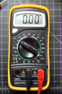 Photo of a multimeter set to measure DC voltage. The dial is pointing to a setting marked 20V in a section of the dial marked with the letter V and a horizontal line with a dashed line under it.