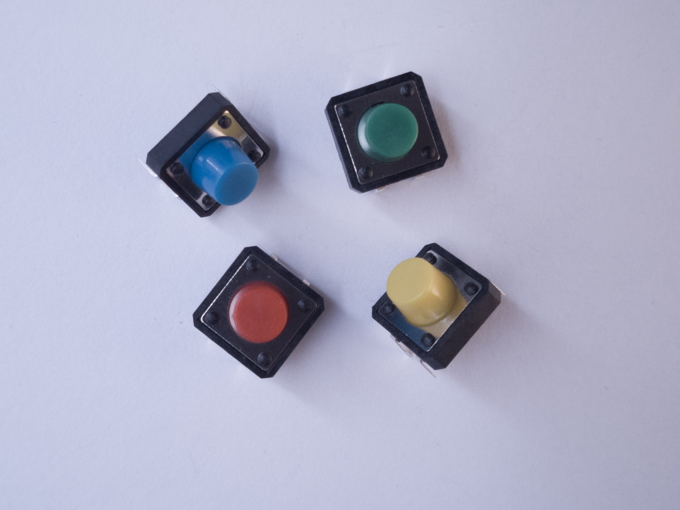 Photo of four breadboard-mounted pushbuttons