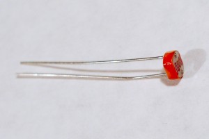 Photocell, or light-dependent resistor. This component has a round top and two wire legs. You measure the resistance between the two legs and expose the top to a varying light source in order to vary the resistance between the two legs.