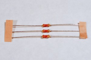 Resistors. Shown here are 220-ohm resistors. You can tell this because they have two red and one brown band, followed by a gold band.