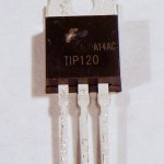 TIP120 transistor. The transistor here has the same physical package as the voltage regulators shown above. It has three legs and a tab at the top with a hole in it. The tab is the back of the component. If you hold the component with the tab at the top and the bulging side of the component facing you, the legs will be arranged, from left to right, base, collector, emitter. The only way to know the difference between two components of the same package is to read the label on the package, unfortunately. This one is labeled TIP120.