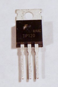 TIP120 transistor. The transistor here has the same physical package as the voltage regulators shown above. It has three legs and a tab at the top with a hole in it. The tab is the back of the component. If you hold the component with the tab at the top and the bulging side of the component facing you, the legs will be arranged, from left to right, base, collector, emitter. The only way to know the difference between two components of the same package is to read the label on the package, unfortunately. This one is labeled TIP120.