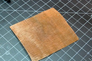 Photo of copper mesh wire, approximately 4 inches (10cm) square. The mesh has holes slightly smaller than 1mm.