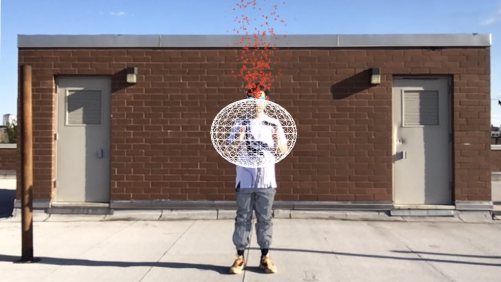 An enby holds a virtual white 3D ellipse in front of their body hiding their face on a building's rooftop. Orange triangles come out of their head looking like fire.