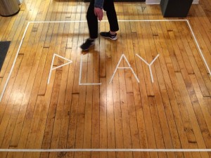 play in white tape on wood floor