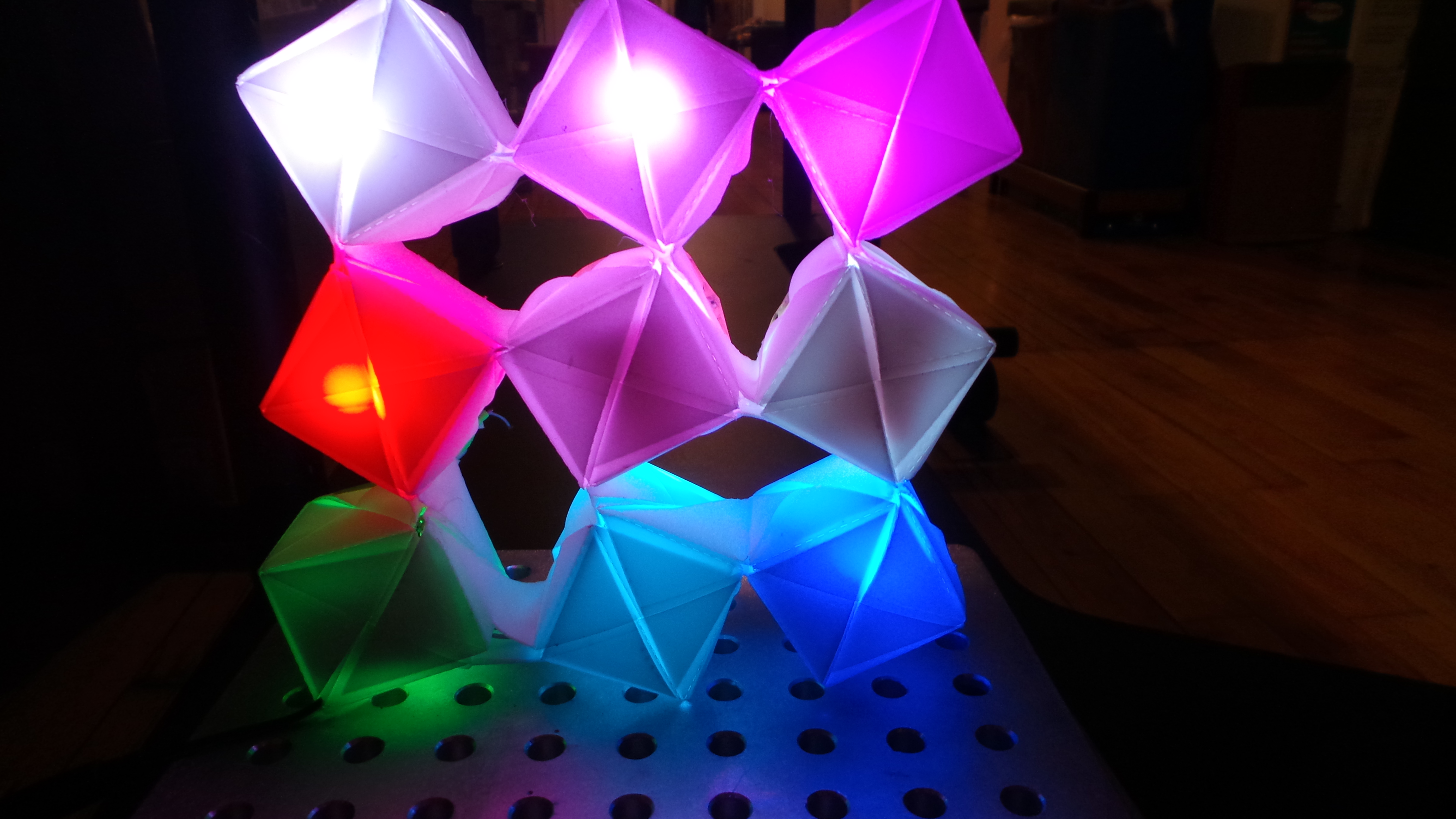 Interactive modular origami lights that responds to change in physical arrangement.