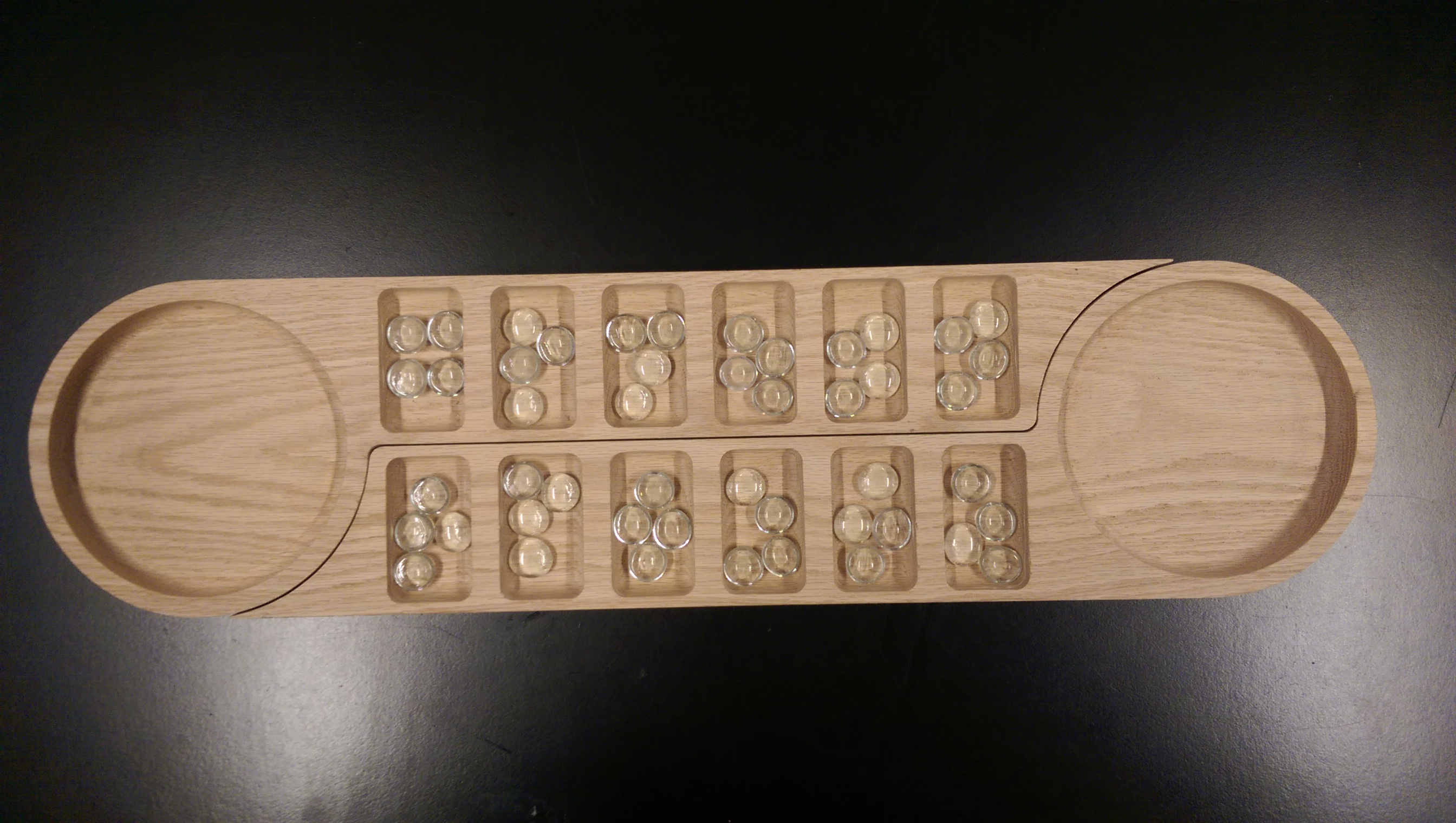 A mancala game that can be expanded for use by more than two players.