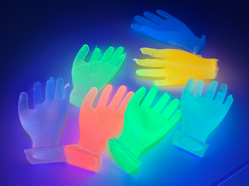 Hands lit up by a UV led matrix.