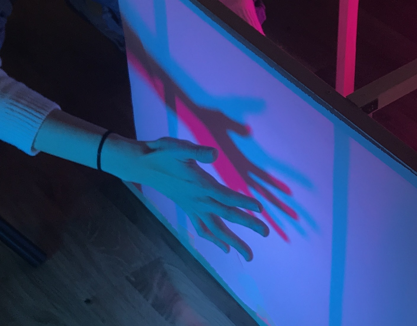 A two-way wall that detects the intersection of two people's shadows to trigger music.