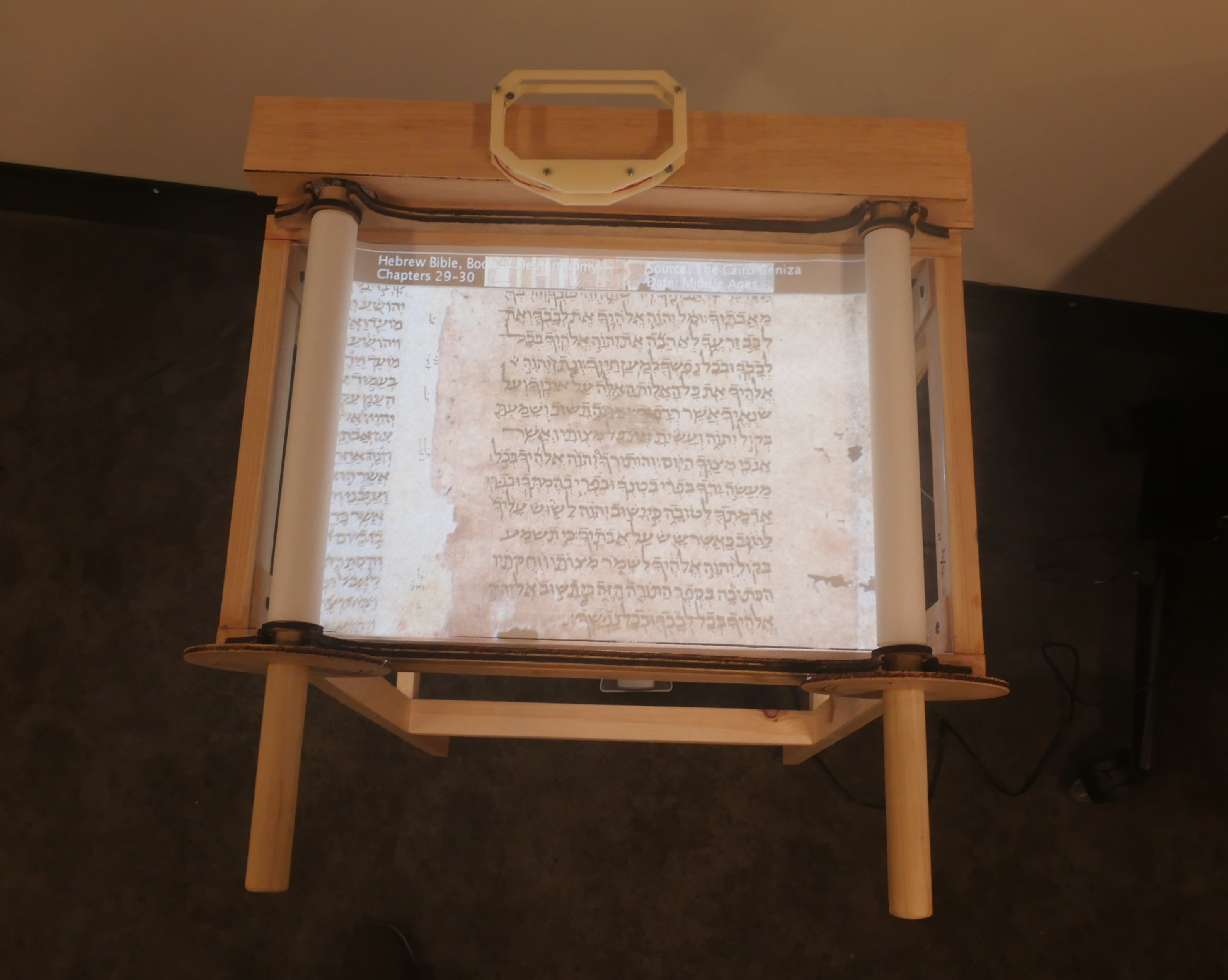 an interactive installation that allows the user to physically interact with a projected version of an ancient scroll