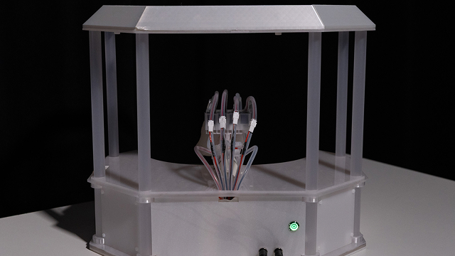 the back of the altar-like structure containing a soft robotic hand