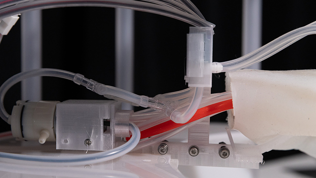 The side profile of the soft robotic hand, showing the cables and mounting mechanism
