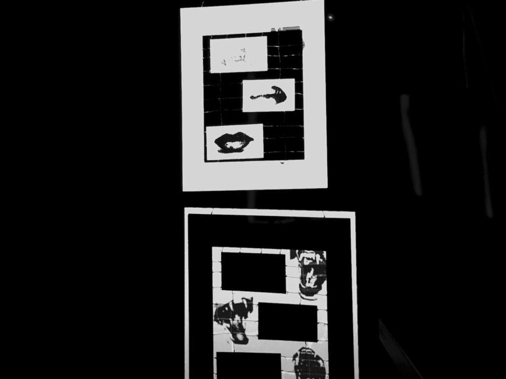 first artwork is a paper sculpture made of lips connected nby wires, violent animals pictured behind it