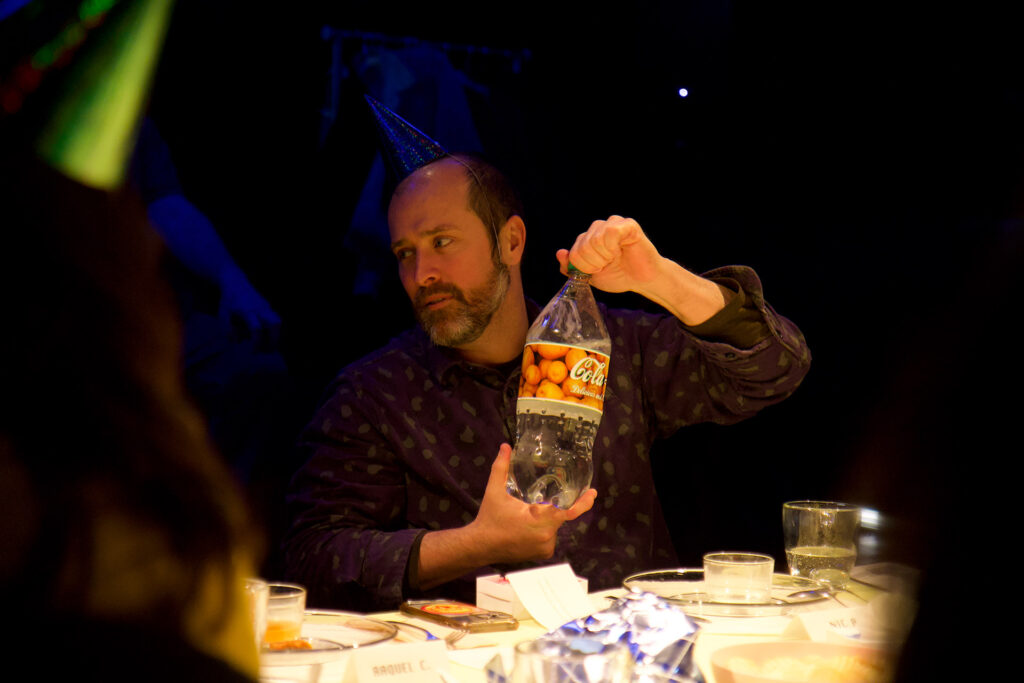 A guest shows off a bottle of potato soda.