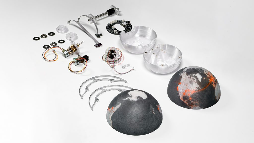 Electronic and mechanical components laid out over a white surface