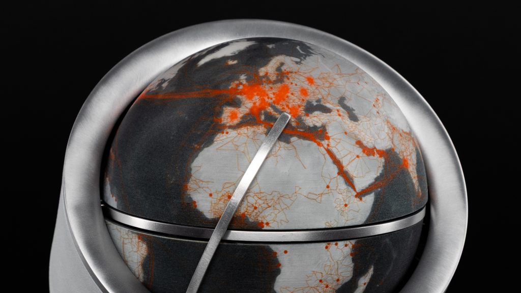 Zoomed in photo a globe with a metal indicator pointing at the Balkans