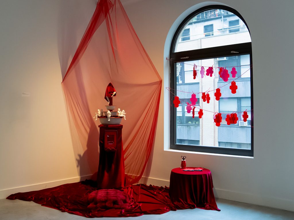 a fountain placed on a red fabric