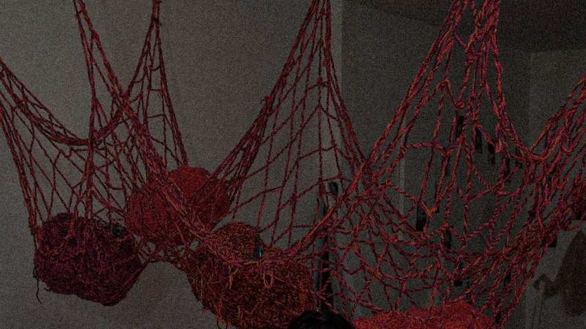 pink, red, and orange net suspended in a gallery