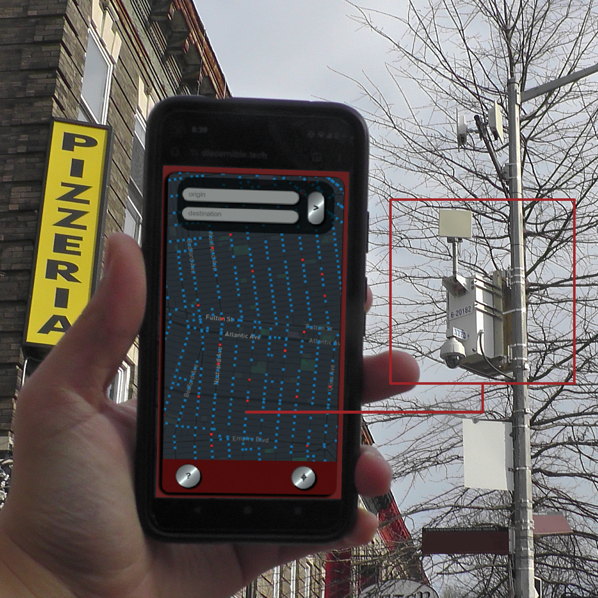 An image of a mobile phone being held up towards the sky with a dot filled map on its screen. In the background a surveillance camera mounted to a utility pole is visible. The image has an overlayed graphic which includes a red box outline around the surveillance camera leading by way of a thin red line to a single dot on the screen of the mobile device.