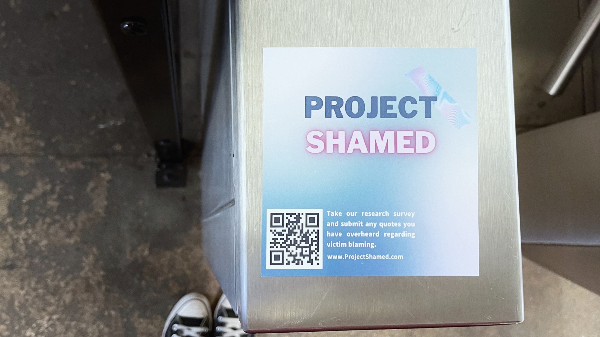 Project Shamed hashtag written on the sidewalk in chalk.