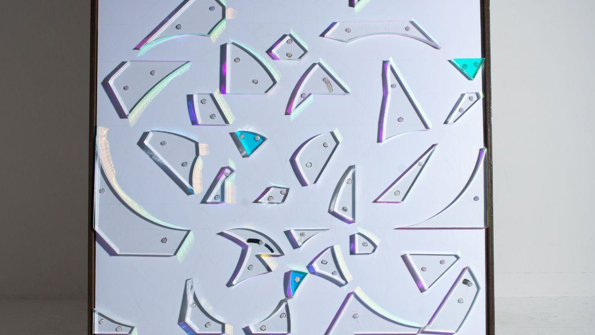 Front view of Frameworks: Of The Mind. Dichroic prisms placed as obstacles on white board.