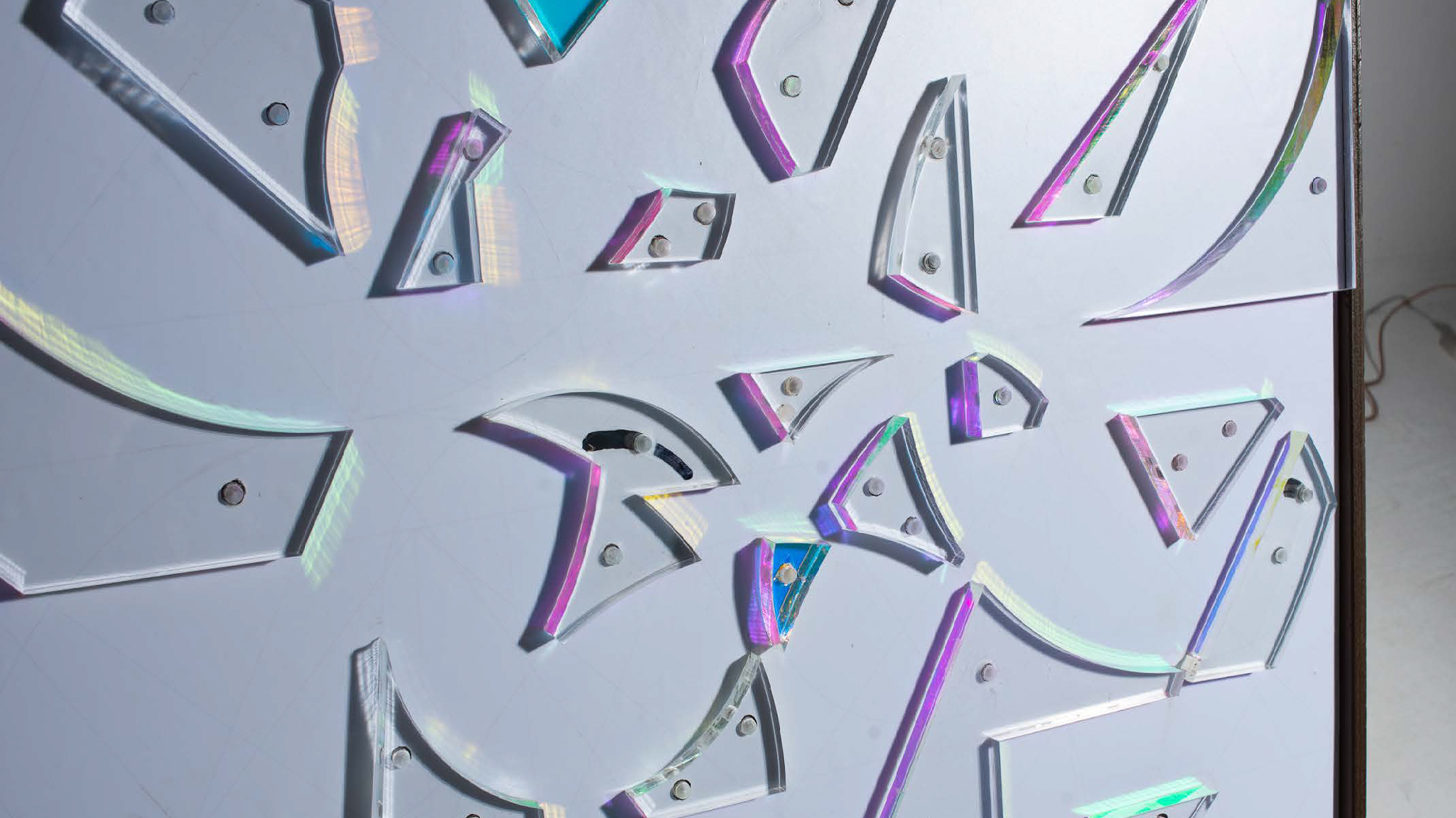 Angled view of Frameworks: Of The Mind. Dichroic prisms placed as obstacles on white board.